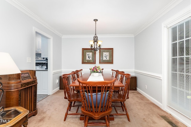 165 Baron Cir, Youngsville, NC 27596 - dining space featuring a chandelier, light colored carpet, and crown molding