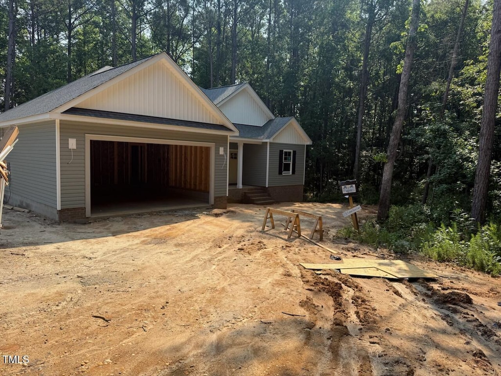 211 Rollins Acres Ln, Lillington, NC 27546 - view of front of home with a garage, roof with shingles, and driveway