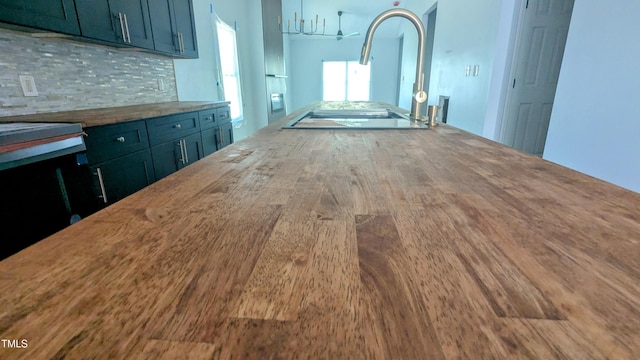 109 N Dunn St, Angier, NC 27501 - kitchen featuring tasteful backsplash, black electric cooktop, wood finished floors, and range