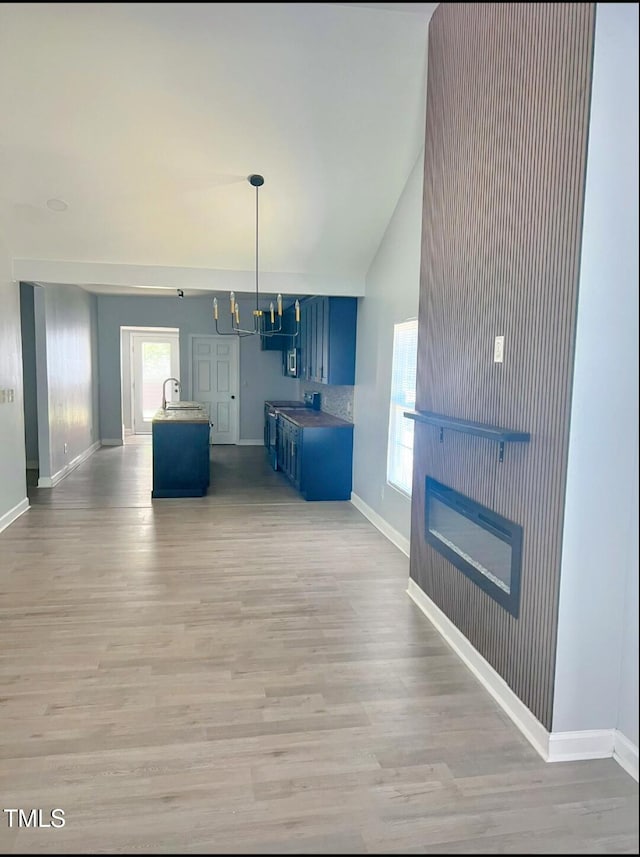 109 N Dunn St, Angier, NC 27501 - living area with light wood-style flooring, healthy amount of natural light, and vaulted ceiling