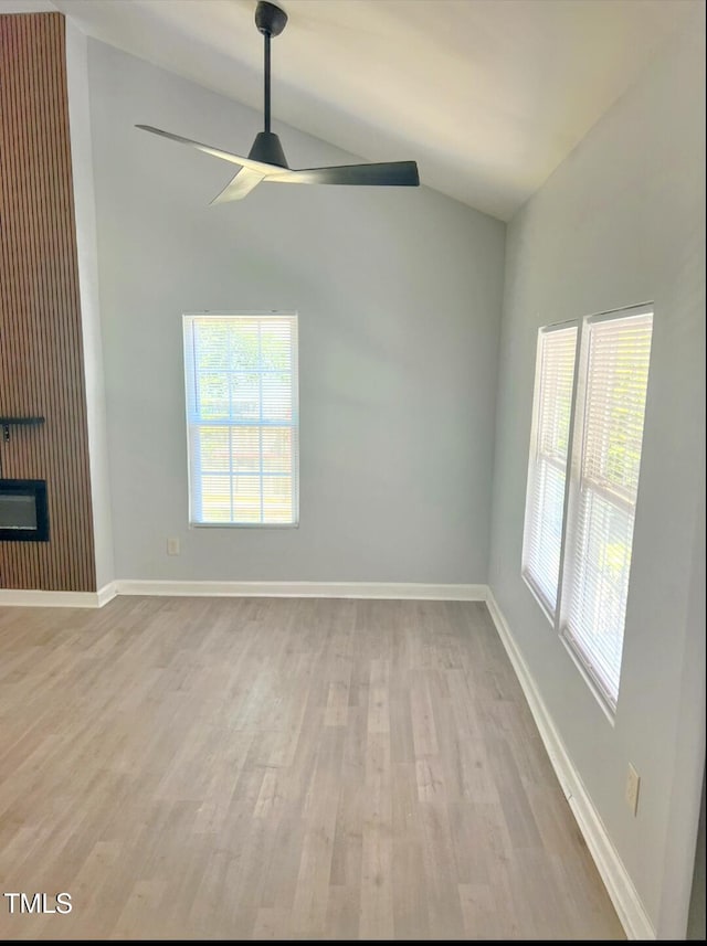 109 N Dunn St, Angier, NC 27501 - empty room featuring a ceiling fan, lofted ceiling, light wood-style flooring, and healthy amount of natural light