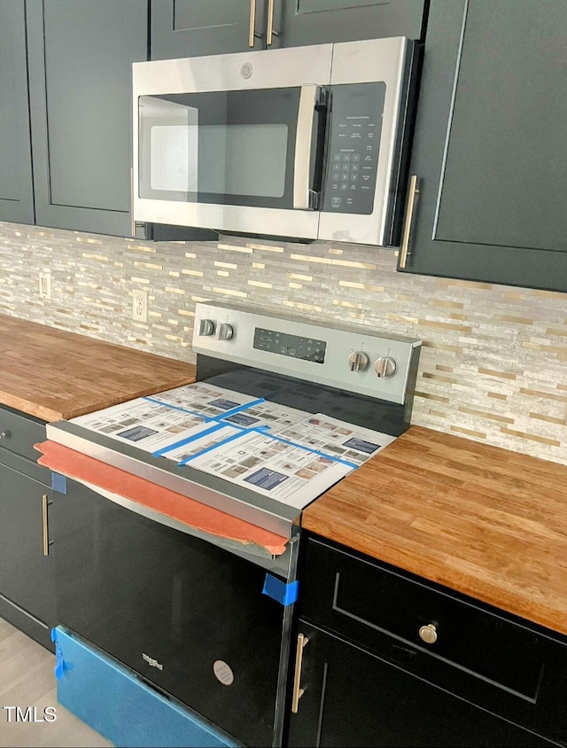 109 N Dunn St, Angier, NC 27501 - kitchen featuring stainless steel appliances, backsplash, light wood finished floors, and wooden counters