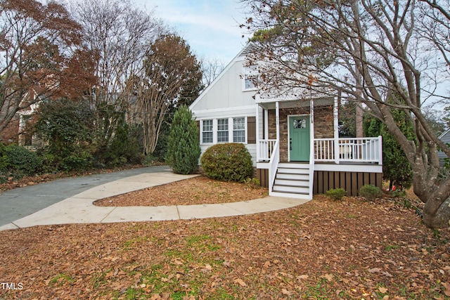 625 New Rd, Raleigh, NC 27608 - view of front of house featuring board and batten siding, a porch, and stone siding