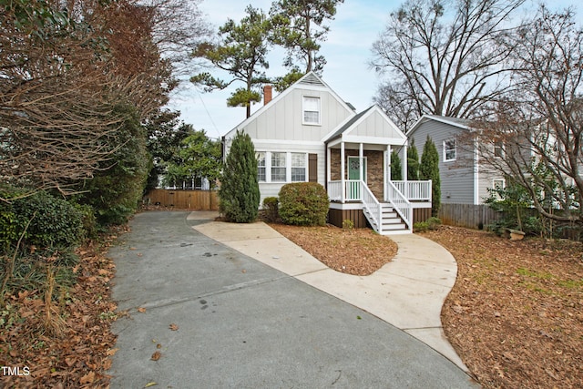 625 New Rd, Raleigh, NC 27608 - bungalow-style house with board and batten siding, a porch, and a chimney