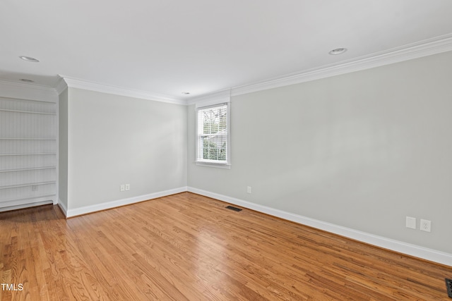 625 New Rd, Raleigh, NC 27608 - spare room featuring ornamental molding, light wood finished floors, built in features, and recessed lighting