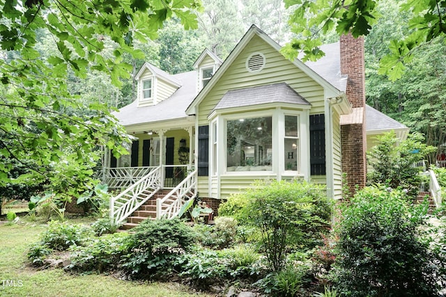7216 Rabbit Run, Wake Forest, NC 27587 - view of front of house with stairs, a chimney, and covered porch