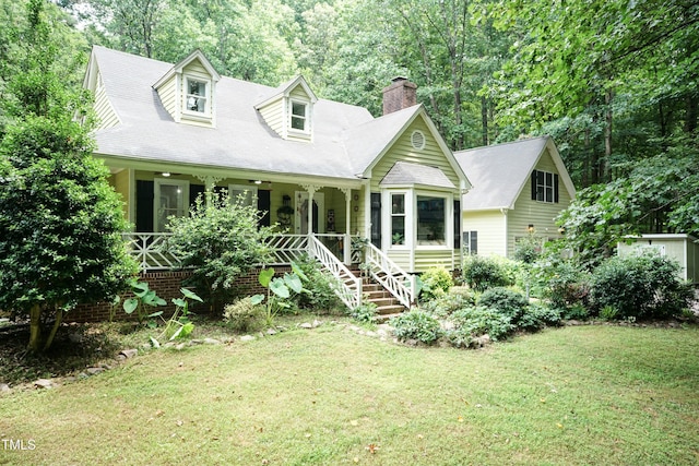 7216 Rabbit Run, Wake Forest, NC 27587 - new england style home featuring a chimney, a porch, and a front yard