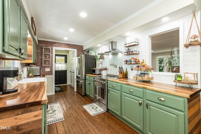 7216 Rabbit Run, Wake Forest, NC 27587 - kitchen featuring wooden counters, wall chimney exhaust hood, premium appliances, green cabinets, and crown molding