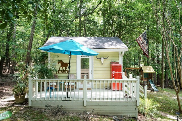 7216 Rabbit Run, Wake Forest, NC 27587 - view of front of home featuring an outdoor structure, a shingled roof, and a wooden deck