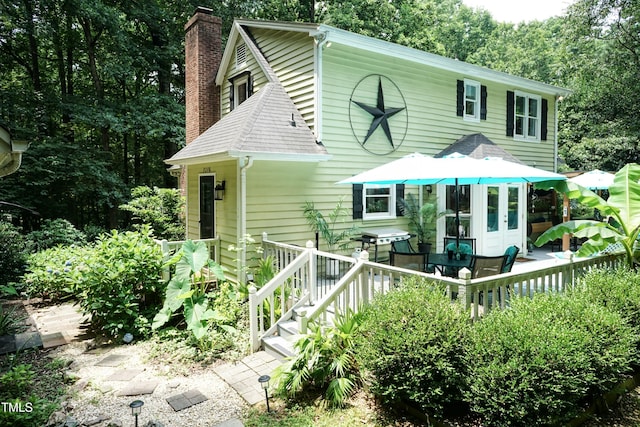 7216 Rabbit Run, Wake Forest, NC 27587 - view of front of home with a chimney, french doors, and roof with shingles