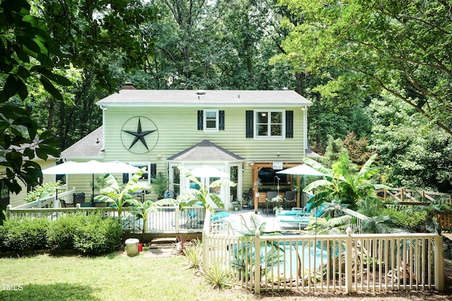 7216 Rabbit Run, Wake Forest, NC 27587 - back of property featuring a deck, an outdoor pool, and a chimney