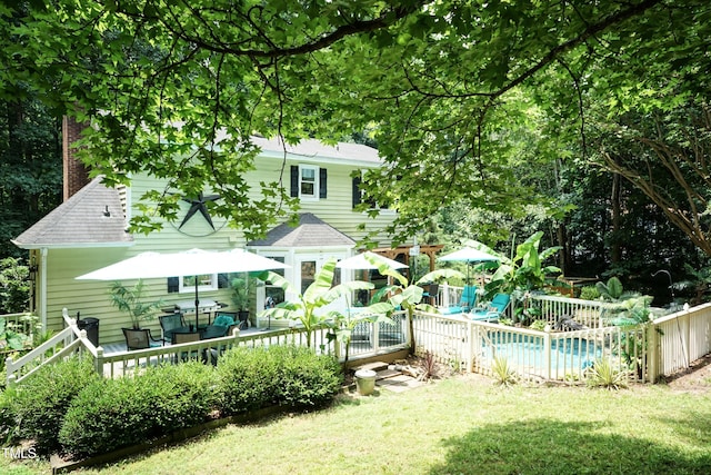 7216 Rabbit Run, Wake Forest, NC 27587 - rear view of house with a deck, an outdoor pool, and a shingled roof