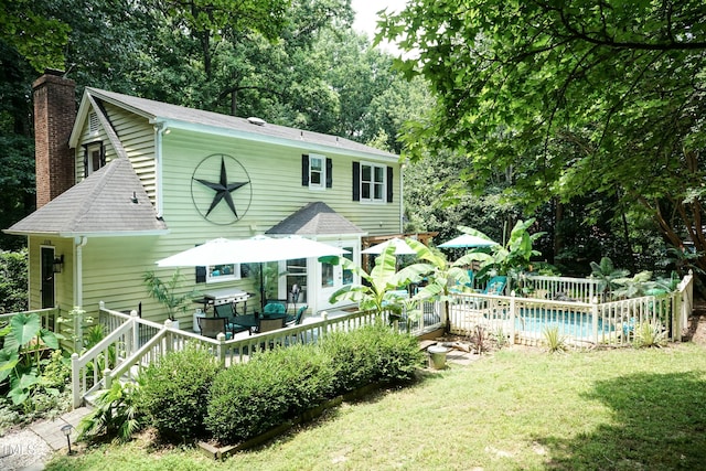 7216 Rabbit Run, Wake Forest, NC 27587 - view of front of home with a deck, a chimney, a front yard, and roof with shingles