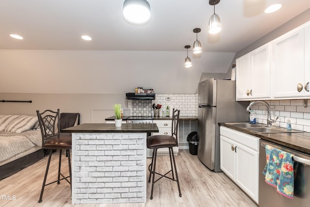7216 Rabbit Run, Wake Forest, NC 27587 - kitchen featuring appliances with stainless steel finishes, a breakfast bar, white cabinets, decorative backsplash, and recessed lighting