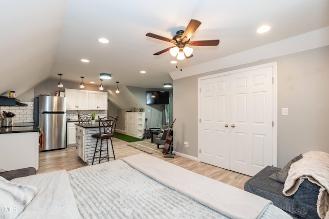7216 Rabbit Run, Wake Forest, NC 27587 - bedroom featuring freestanding refrigerator, light wood-style flooring, recessed lighting, and vaulted ceiling
