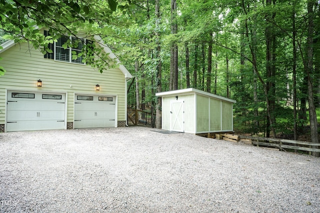 7216 Rabbit Run, Wake Forest, NC 27587 - garage featuring gravel driveway and a storage shed