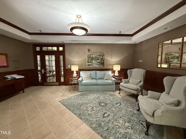 3701 Baron Cooper Pass Unit 303, Raleigh, NC 27612 - tiled living room with a raised ceiling, ornamental molding, and a wainscoted wall