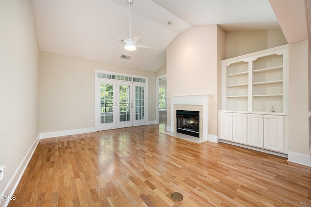 3701 Baron Cooper Pass Unit 303, Raleigh, NC 27612 - unfurnished living room featuring ceiling fan, light wood finished floors, high vaulted ceiling, a premium fireplace, and french doors