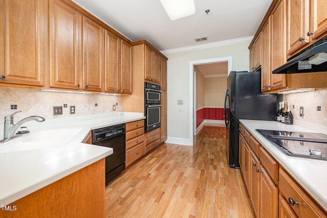 3701 Baron Cooper Pass Unit 303, Raleigh, NC 27612 - kitchen with black appliances, ornamental molding, under cabinet range hood, light wood-type flooring, and backsplash
