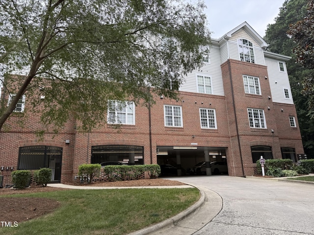 3701 Baron Cooper Pass Unit 303, Raleigh, NC 27612 - view of building exterior featuring driveway and an attached garage