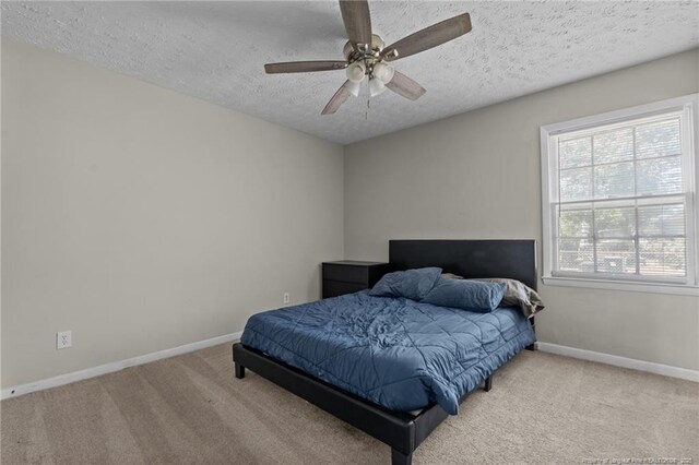 3649 Marcliff Rd, Hope Mills, NC 28348 - carpeted bedroom with a textured ceiling and ceiling fan