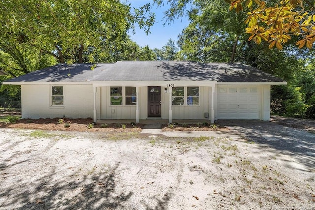 1809 Wendover Dr, Fayetteville, NC 28304 - ranch-style house with an attached garage, driveway, board and batten siding, and brick siding