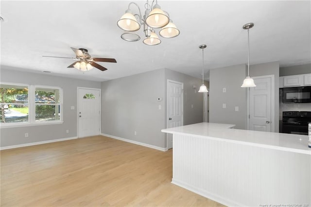 1809 Wendover Dr, Fayetteville, NC 28304 - kitchen featuring black appliances, a ceiling fan, light countertops, light wood finished floors, and hanging light fixtures