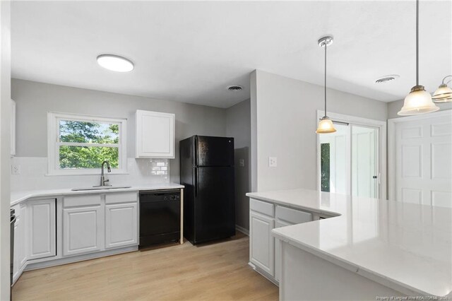 1809 Wendover Dr, Fayetteville, NC 28304 - kitchen featuring black appliances, backsplash, white cabinets, light wood-style floors, and pendant lighting