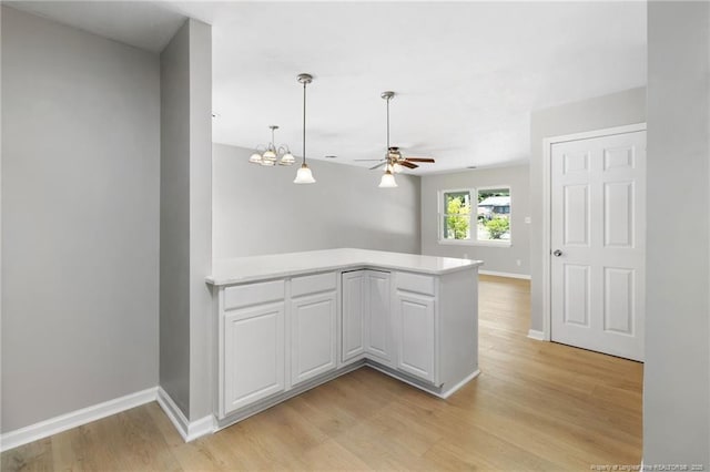 1809 Wendover Dr, Fayetteville, NC 28304 - kitchen featuring a peninsula, light countertops, light wood-style floors, and a ceiling fan