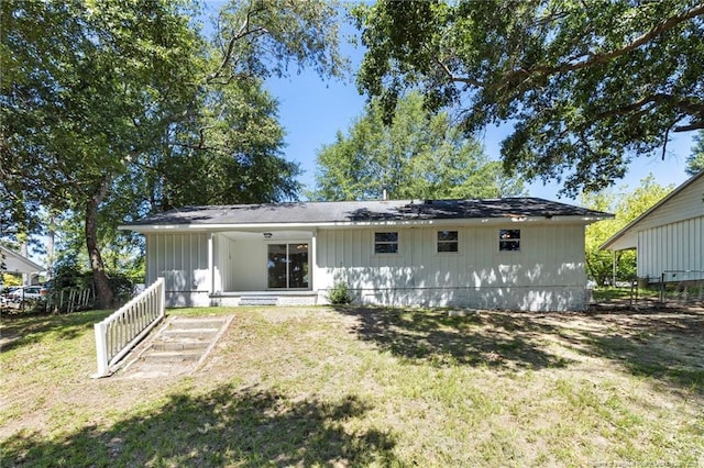 1809 Wendover Dr, Fayetteville, NC 28304 - rear view of property with board and batten siding and a yard