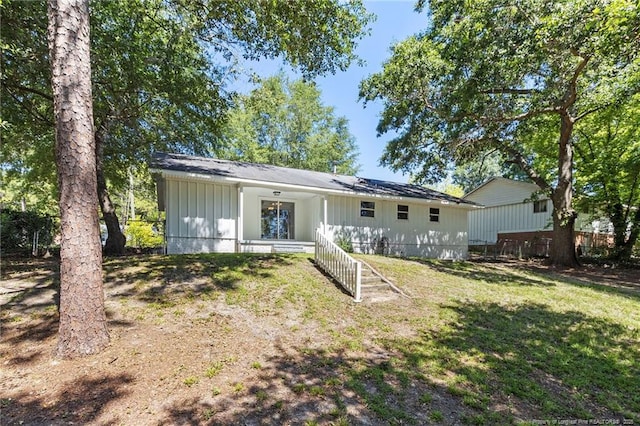 1809 Wendover Dr, Fayetteville, NC 28304 - back of property with board and batten siding and a lawn