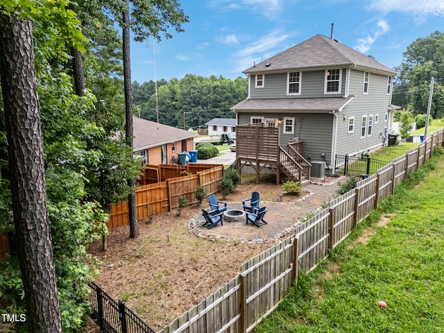 1819 Nixon St, Durham, NC 27707 - back of house with an outdoor fire pit, a shingled roof, a fenced backyard, and a deck