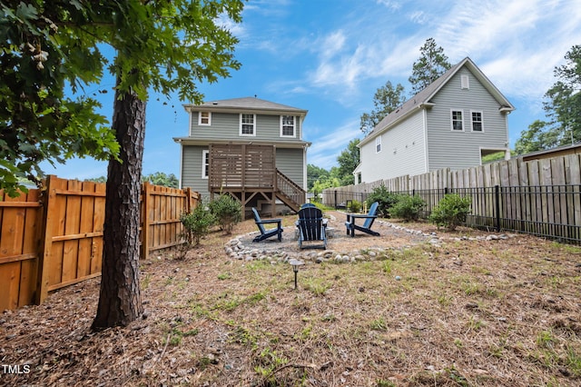 1819 Nixon St, Durham, NC 27707 - rear view of house featuring an outdoor fire pit and a fenced backyard