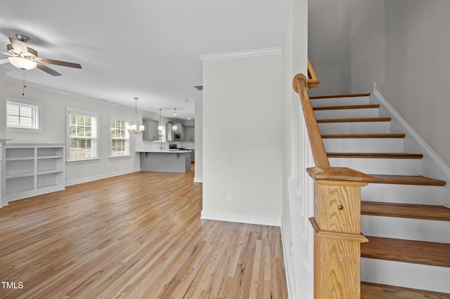 1819 Nixon St, Durham, NC 27707 - stairway featuring a ceiling fan, crown molding, wood finished floors, and a chandelier
