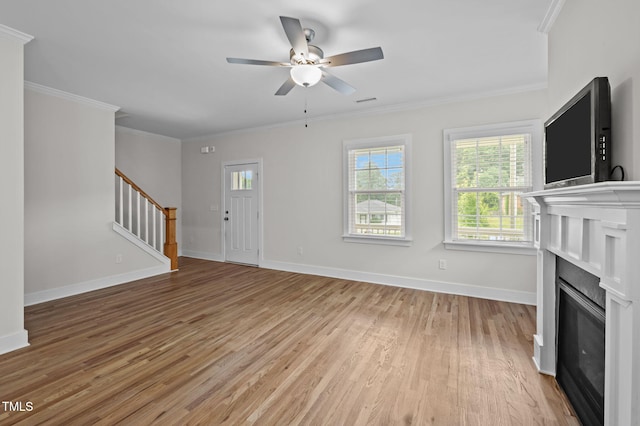 1819 Nixon St, Durham, NC 27707 - unfurnished living room with stairs, light wood-type flooring, crown molding, a ceiling fan, and a glass covered fireplace