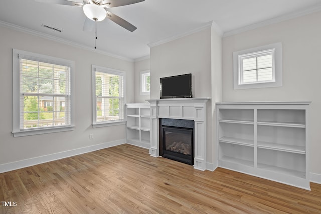 1819 Nixon St, Durham, NC 27707 - unfurnished living room with light wood-style flooring, a ceiling fan, ornamental molding, and a glass covered fireplace