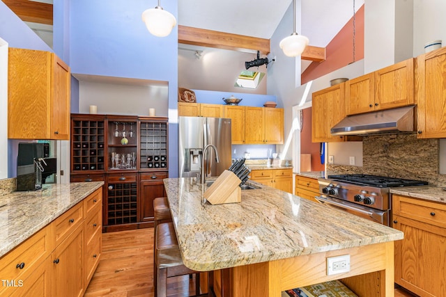28 Benchmark, Pittsboro, NC 27312 - kitchen with appliances with stainless steel finishes, under cabinet range hood, high vaulted ceiling, light wood-type flooring, and beam ceiling