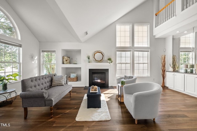 1308 Snyder St, Durham, NC 27713 - living room featuring high vaulted ceiling, a fireplace with flush hearth, and dark wood-style floors
