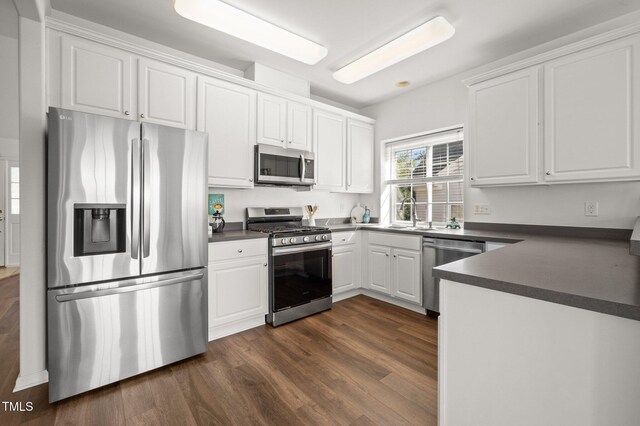 1308 Snyder St, Durham, NC 27713 - kitchen featuring stainless steel appliances, dark countertops, and white cabinets