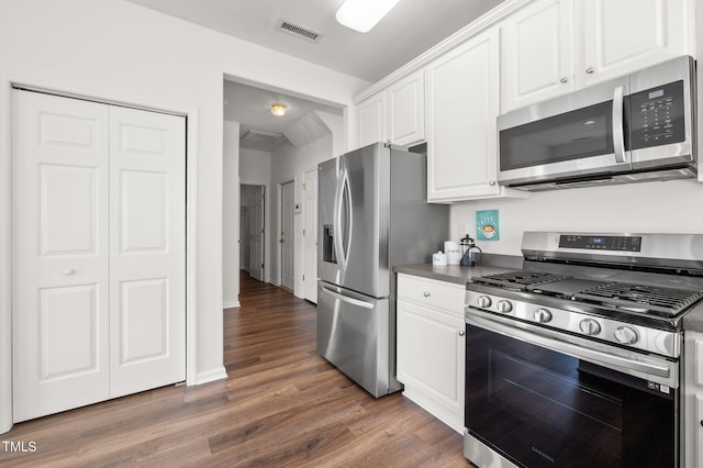 1308 Snyder St, Durham, NC 27713 - kitchen with stainless steel appliances, white cabinets, dark wood-style floors, and dark countertops
