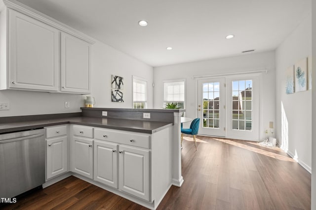 1308 Snyder St, Durham, NC 27713 - kitchen with stainless steel dishwasher, dark countertops, a peninsula, white cabinetry, and recessed lighting
