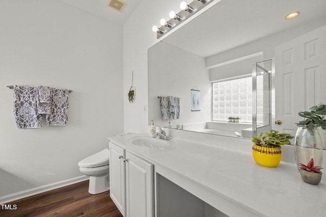 1308 Snyder St, Durham, NC 27713 - full bathroom with vanity, a shower stall, wood finished floors, and recessed lighting