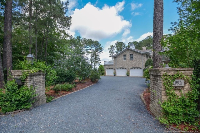 1064 Tresses Ct, Vass, NC 28394 - view of front of property featuring driveway, a garage, and a chimney