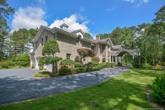 1064 Tresses Ct, Vass, NC 28394 - view of property exterior with a lawn, asphalt driveway, a chimney, a garage, and stone siding
