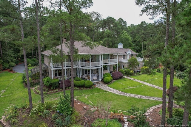 1064 Tresses Ct, Vass, NC 28394 - back of house with a balcony, a yard, a view of trees, and covered porch