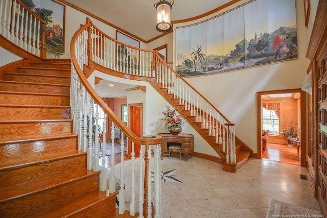1064 Tresses Ct, Vass, NC 28394 - staircase with a towering ceiling and crown molding