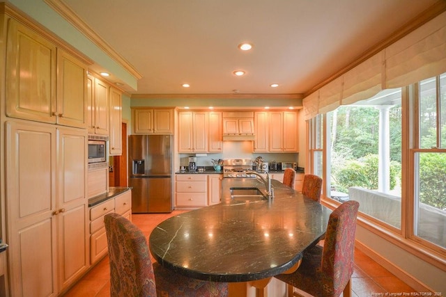 1064 Tresses Ct, Vass, NC 28394 - kitchen with appliances with stainless steel finishes, ornamental molding, dark countertops, light tile patterned floors, and a large island with sink