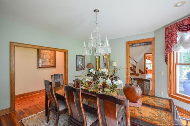1064 Tresses Ct, Vass, NC 28394 - dining space with a chandelier, stairs, and wood finished floors