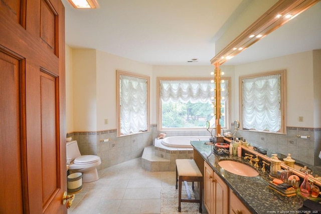 1064 Tresses Ct, Vass, NC 28394 - full bath featuring a bath, tile patterned floors, tile walls, wainscoting, and vanity