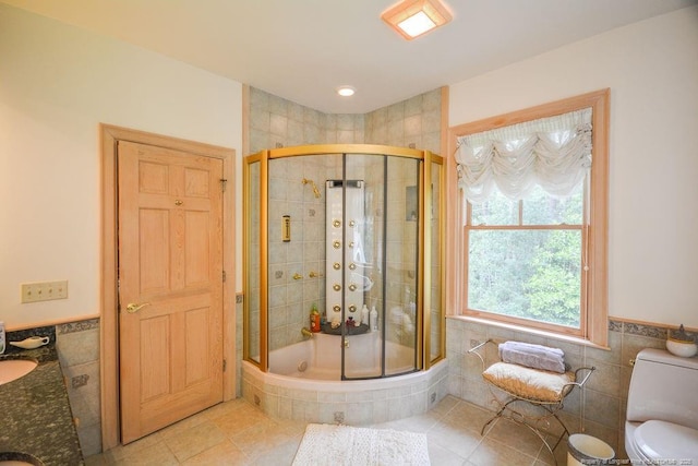 1064 Tresses Ct, Vass, NC 28394 - bathroom with tile walls, a shower stall, tile patterned floors, and wainscoting